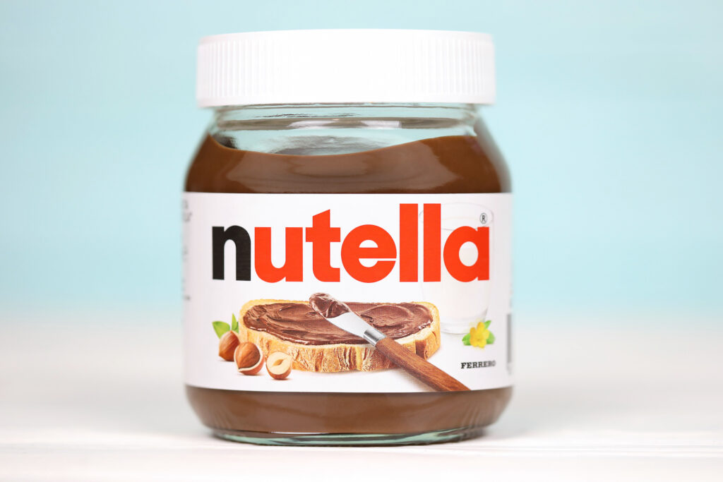 KHARKOV, UKRAINE - DECEMBER 27, 2020: Nutella classic glass can. Nutella is manufactured by Italian company Ferrero first introduced in 1964