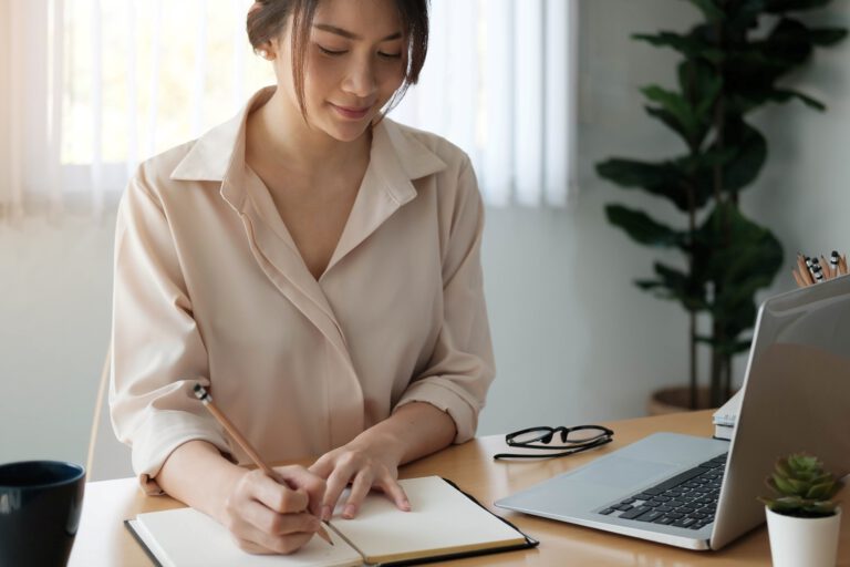 vecteezy_woman-writing-in-a-notebook_2260943