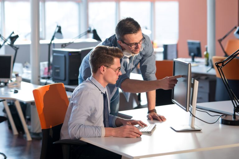 vecteezy_two-business-people-working-with-computer-in-office_12436916