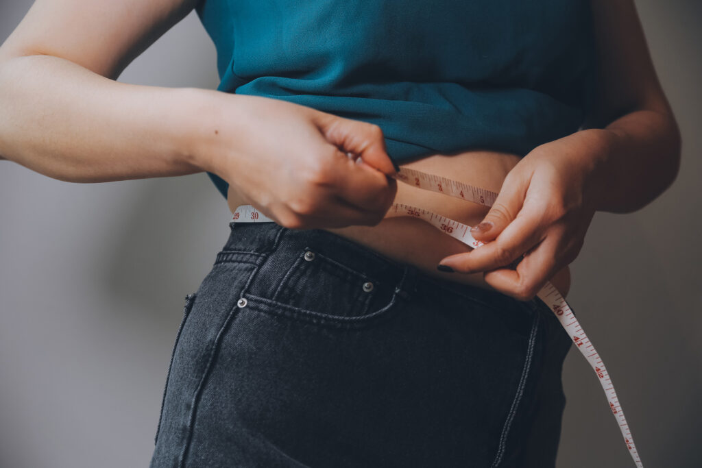 Frau misst ihren Bauch