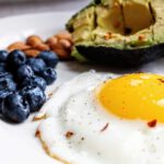 Spiegelei, Avocado und Blaubeeren passen zu einer kohlenhydratarmen Ernährung. In der Studie war die Keto-Kost allerdings deutlich strenger zusammengesetzt.