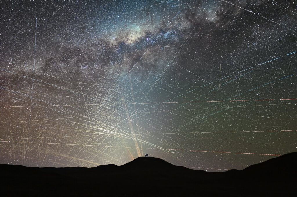 Satellitenspuren über der Atacamawüste: Innerhalb einer Stunde ziehen zahlreiche helle Bahnen über den Himmel, an dem einige der wichtigsten Teleskope der Welt nach fernen Galaxien, Planeten und Asteroiden suchen. © F. Kamphues/ESO/M. Kornmesser