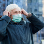 Älterer Mann in der Stadt mit Maske