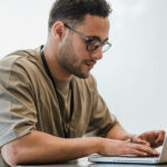 Junger Mann vor dem Laptop